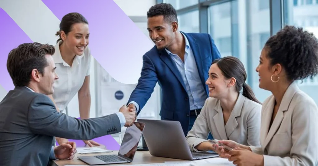 A diverse group of four smiling professionals—two men in suits and two women in business attire—shakes hands and collaborates around a sleek conference table inside the sunlit MadCraft Office, overlooking a cityscape with open laptops, scattered documents, and dynamic purple geometric web design overlays.