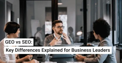 Three business professionals meeting in a modern office conference room, with overlay text reading ‘GEO vs SEO: Key Differences Explained for Business Leaders