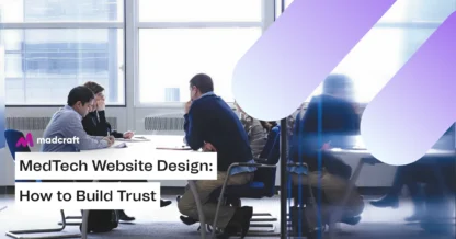 Madcraft team members discussing MedTech website design strategies with a client during a professional office meeting